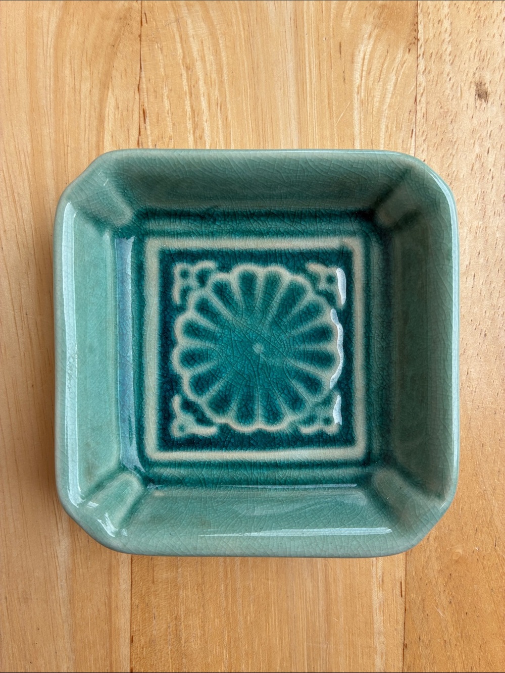 World Market small teal glazed ceramic decorative dish. Floral medallion.